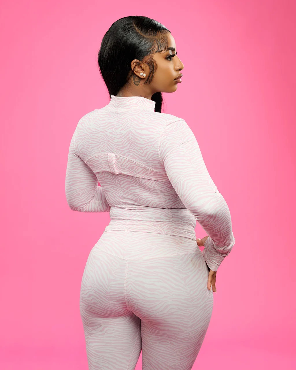 Back view of the ILUREIA pink zebra set, the seaming and the flare of the leg